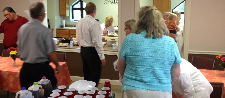 Members sharing a meal together in the fellowship area